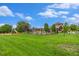 Beautiful community center surrounded by lush green lawn, a playground, and inviting landscaping at 11973 Song Bird Hills St, Parker, CO 80138