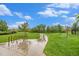 Scenic community park featuring lush green space, walking paths, and bike racks under a partly cloudy sky at 11973 Song Bird Hills St, Parker, CO 80138