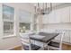 Sunny eat-in dining area with a pendant light fixture, hardwood floors, and three large windows at 11973 Song Bird Hills St, Parker, CO 80138