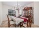 Charming dining room with a window view, elegant chandelier, and classic wooden china cabinet at 11973 Song Bird Hills St, Parker, CO 80138