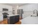 Bright kitchen with white cabinets, stainless steel appliances, and center island at 11973 Song Bird Hills St, Parker, CO 80138