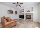 Inviting living room featuring a cozy fireplace, built-in shelving, and travertine flooring at 11973 Song Bird Hills St, Parker, CO 80138