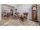 Elegant living room featuring travertine flooring, and a charming grandfather clock and leather chairs at 11973 Song Bird Hills St, Parker, CO 80138