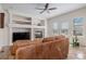 Cozy living room with a fireplace, built-in shelves, and plush leather seating at 11973 Song Bird Hills St, Parker, CO 80138