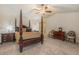 Spacious main bedroom featuring a dark wood four poster bed and neutral carpeting at 11973 Song Bird Hills St, Parker, CO 80138