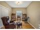 Cozy office with wooden floors, a window view, leather chair, and built-in bookshelves at 11973 Song Bird Hills St, Parker, CO 80138