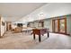 Spacious basement featuring a ping pong table and a foosball table at 3726 Spring Valley Trl, Evergreen, CO 80439