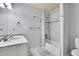 Updated bathroom with white vanity, tile shower, and modern fixtures at 3726 Spring Valley Trl, Evergreen, CO 80439