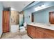Bathroom with a shower and tub, a double sink vanity with great lighting at 3726 Spring Valley Trl, Evergreen, CO 80439