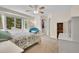 Bright bedroom featuring a bay window, ceiling fan, and neutral colored carpet flooring at 3726 Spring Valley Trl, Evergreen, CO 80439