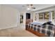 Cozy bedroom with carpet floors showcases an ensuite and large window at 3726 Spring Valley Trl, Evergreen, CO 80439
