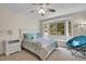 Cozy bedroom featuring a bay window, ceiling fan, and neutral colored carpet flooring at 3726 Spring Valley Trl, Evergreen, CO 80439