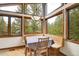 Cozy breakfast nook featuring a built-in bench and large windows overlooking the trees at 3726 Spring Valley Trl, Evergreen, CO 80439