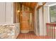 The home's entryway has a wooden door and wooden exterior and stonework for added curb appeal at 3726 Spring Valley Trl, Evergreen, CO 80439