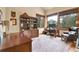 Inviting home office features large windows, a desk, and beautiful views of the outdoors at 3726 Spring Valley Trl, Evergreen, CO 80439