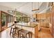 Gourmet kitchen with large island, stone backsplash, stainless appliances, and natural light from many windows at 3726 Spring Valley Trl, Evergreen, CO 80439