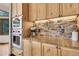 Bright kitchen with stone backsplash, stainless steel oven, light wood cabinets, and lots of counter space at 3726 Spring Valley Trl, Evergreen, CO 80439
