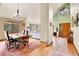 Open layout featuring a dining area leading to a living room, with views of the trees from the windows at 3726 Spring Valley Trl, Evergreen, CO 80439