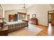 Spacious main bedroom features hardwood floors, large windows, and exterior views at 3726 Spring Valley Trl, Evergreen, CO 80439
