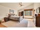 Bright main bedroom boasts a ceiling fan, large windows, and hardwood floors at 3726 Spring Valley Trl, Evergreen, CO 80439