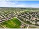 Expansive aerial view of a neighborhood featuring a park, soccer field, playground, green spaces, and multiple homes at 15756 E Aberdeen Ave, Centennial, CO 80016