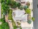 Aerial view of a home with a landscaped yard, pergola, playset, mature trees, and a patterned gray roof at 15756 E Aberdeen Ave, Centennial, CO 80016