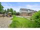 A spacious backyard includes a playground and a charming covered patio for relaxation at 15756 E Aberdeen Ave, Centennial, CO 80016