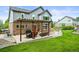 An inviting backyard featuring a covered patio with outdoor seating and a lush green lawn at 15756 E Aberdeen Ave, Centennial, CO 80016