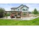 Backyard featuring a large patio, a pergola, and ample green space at 15756 E Aberdeen Ave, Centennial, CO 80016