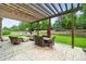 A covered patio showcases an outdoor dining area and lounge furniture, perfect for entertaining at 15756 E Aberdeen Ave, Centennial, CO 80016