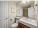 Well-lit bathroom with a single sink vanity, neutral wall colors, and a view of a glass-enclosed shower at 15756 E Aberdeen Ave, Centennial, CO 80016