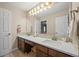 Bathroom featuring double sinks, a large mirror and dark wood cabinetry at 15756 E Aberdeen Ave, Centennial, CO 80016