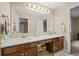 Bathroom featuring double sinks, a large mirror, and stylish fixtures at 15756 E Aberdeen Ave, Centennial, CO 80016
