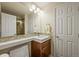 Clean and well-maintained bathroom featuring a single sink vanity, a mirror, and a glass-enclosed shower at 15756 E Aberdeen Ave, Centennial, CO 80016
