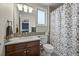 Bright bathroom featuring a wood vanity, white countertop and mosaic tile backsplash, creating a clean and modern design at 15756 E Aberdeen Ave, Centennial, CO 80016