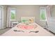 Bedroom with neutral walls and carpet, featuring a unicorn themed bed and two windows at 15756 E Aberdeen Ave, Centennial, CO 80016