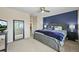 Bedroom with a navy accent wall and a gray upholstered bed frame at 15756 E Aberdeen Ave, Centennial, CO 80016