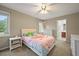 Bright bedroom with a ceiling fan, a window, and a pink unicorn themed bedspread at 15756 E Aberdeen Ave, Centennial, CO 80016