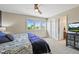 Bright bedroom featuring multiple windows and a television at 15756 E Aberdeen Ave, Centennial, CO 80016