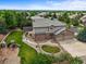 Aerial view of a two-story home with brick and siding, a well-maintained yard, and a play area for the  at 15756 E Aberdeen Ave, Centennial, CO 80016