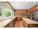 Spacious kitchen featuring stainless steel appliances, an island, and generous counter space by a large window at 15756 E Aberdeen Ave, Centennial, CO 80016