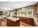 Bright kitchen with stainless steel appliances, countertop island, and a window overlooking the backyard at 15756 E Aberdeen Ave, Centennial, CO 80016