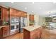 Modern kitchen with stainless steel appliances, an island, and ample cabinet space at 15756 E Aberdeen Ave, Centennial, CO 80016