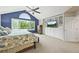 This main bedroom has built-in shelves, a large window, and a vaulted ceiling, exuding comfort at 15756 E Aberdeen Ave, Centennial, CO 80016