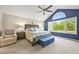 A serene main bedroom with a vaulted ceiling, large window, and a cozy sitting area at 15756 E Aberdeen Ave, Centennial, CO 80016