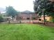 Expansive backyard featuring a lush lawn, mature trees, and a rustic wood fence at 7079 Estes Dr, Arvada, CO 80004