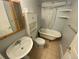 Bathroom featuring vintage-style clawfoot tub, pedestal sink, and storage cabinet at 7079 Estes Dr, Arvada, CO 80004