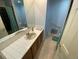 Bright bathroom features tile floor and countertop, vanity, and a large mirror for a sleek look at 7079 Estes Dr, Arvada, CO 80004