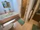 Bright bathroom features a shower, jetted tub, and tile flooring, plus a door leading to another room at 7079 Estes Dr, Arvada, CO 80004