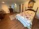 Cozy bedroom features hardwood floors, a quilt-covered bed, and a calming, neutral color palette at 7079 Estes Dr, Arvada, CO 80004